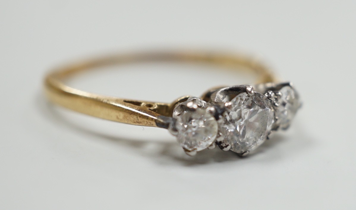 An 18ct and three stone diamond set ring, size, T/U, gross weight 2.9 grams